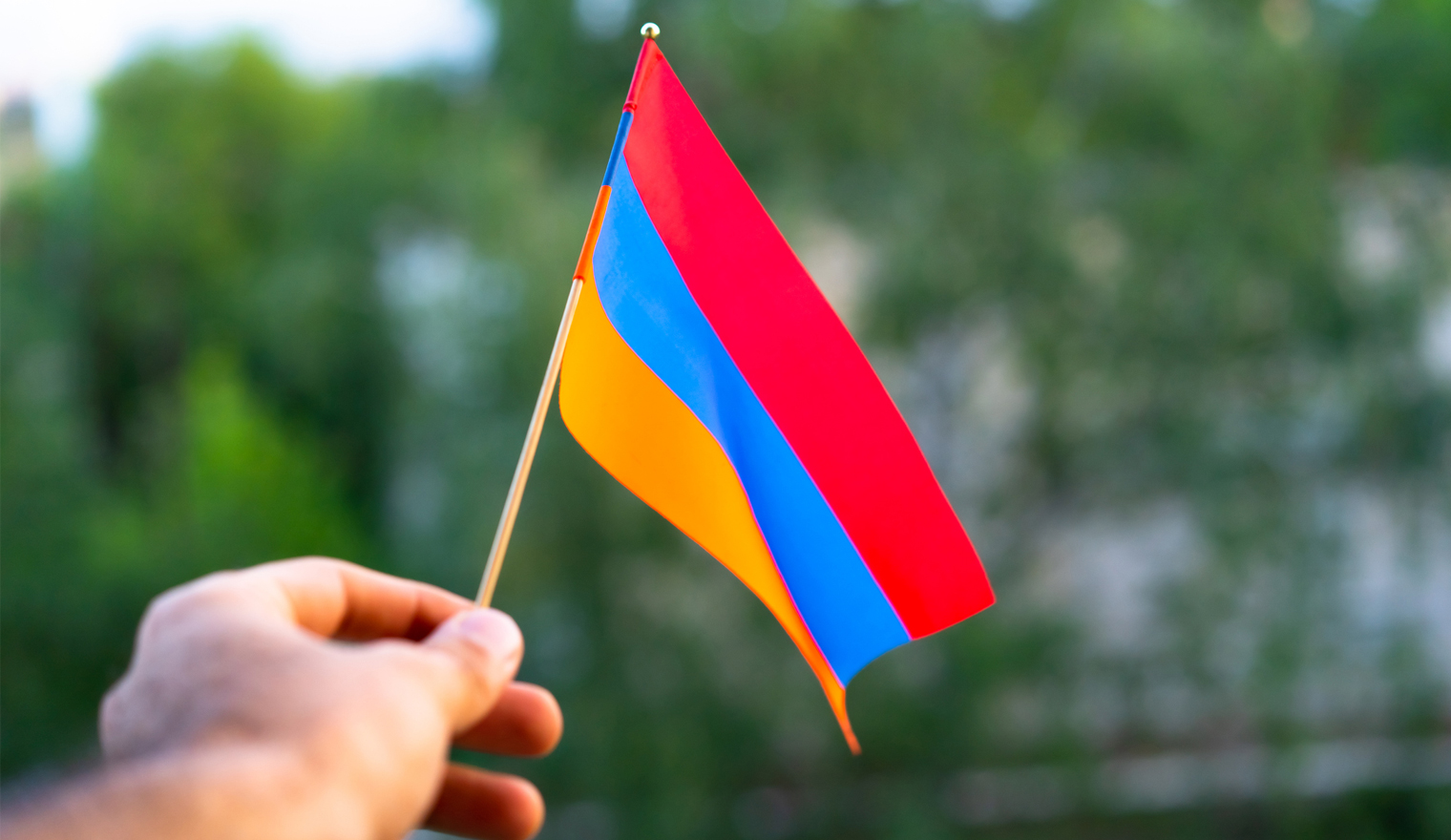 Hand holding Armenian flag