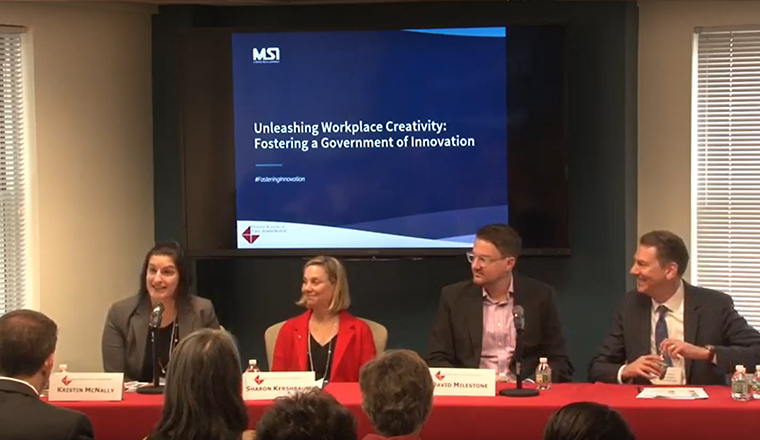Four individuals speak on a panel about innovation in government