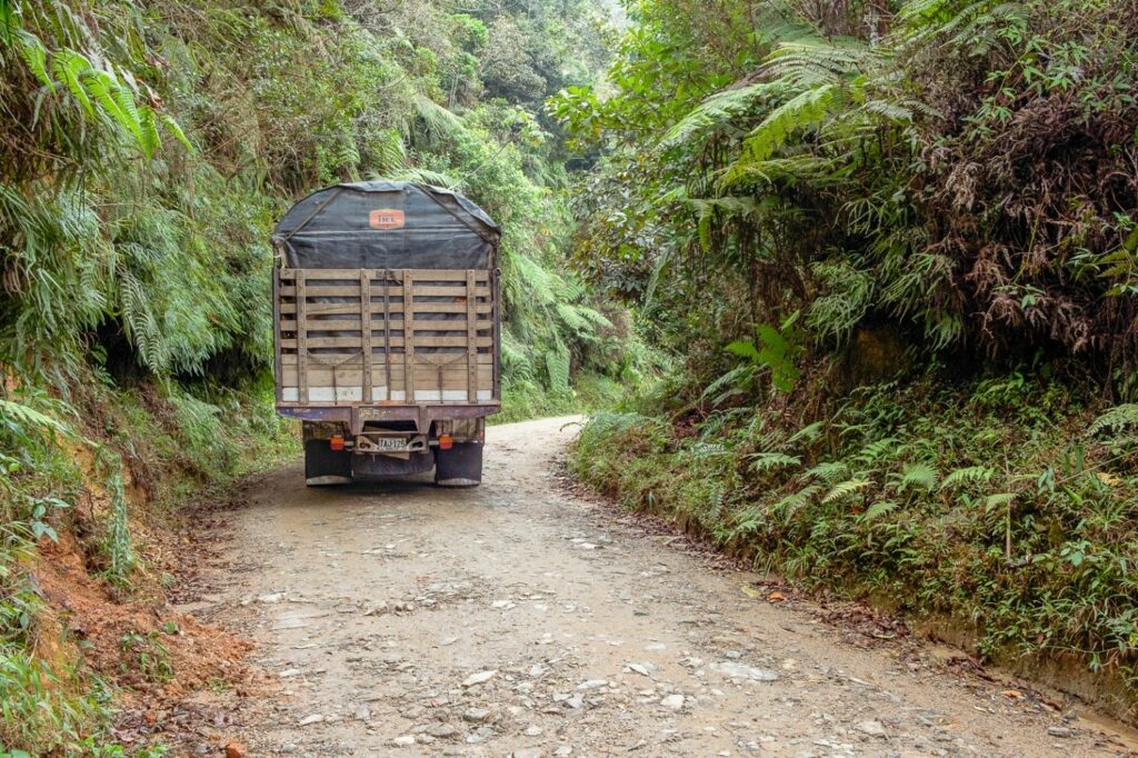 Truck driving away on an unpaved road